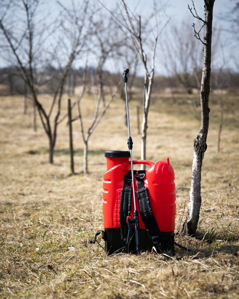 Red sprayer in spring garden